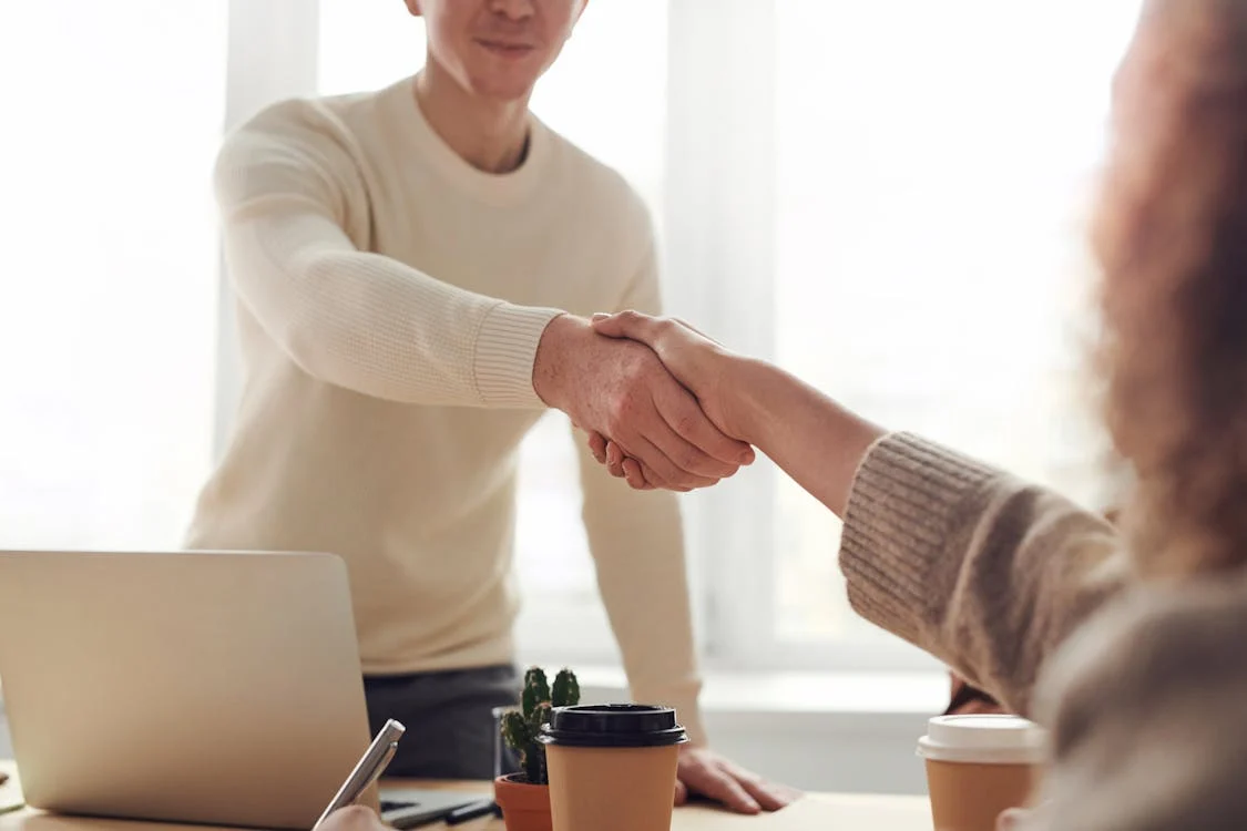 People shaking hands after successful family mediation.